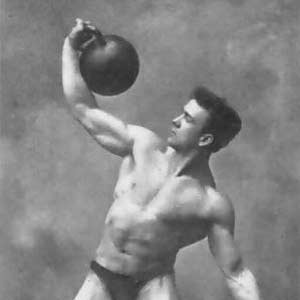 Strongman is doing windmill with kettlebell